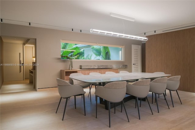 dining room featuring rail lighting and light wood-type flooring