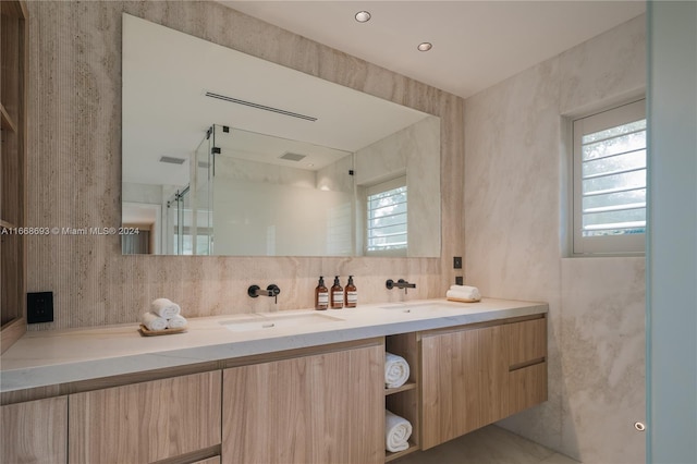 bathroom featuring vanity and an enclosed shower