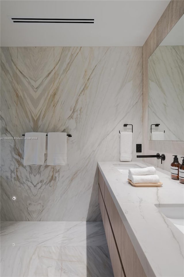 bathroom featuring tile walls and vanity