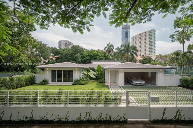 back of property featuring a carport and a lawn