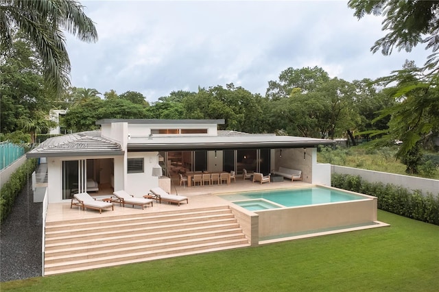 rear view of house with a fenced in pool, a patio area, and a lawn