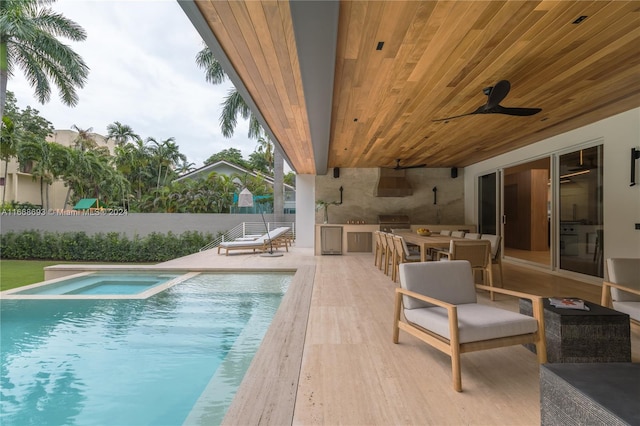 view of swimming pool with a patio area, area for grilling, and ceiling fan