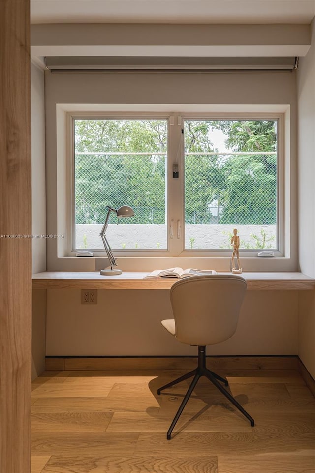 interior space featuring light hardwood / wood-style flooring, a healthy amount of sunlight, and built in desk