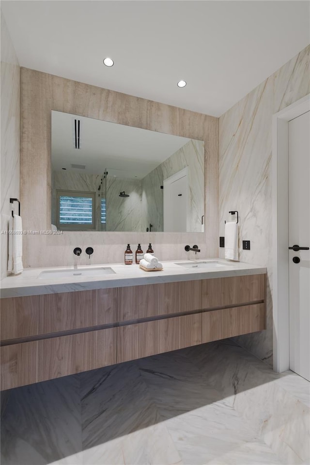 bathroom featuring vanity, a shower, and tile walls