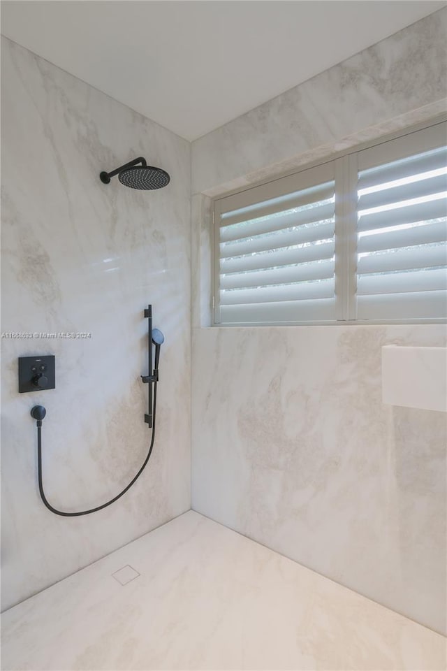 bathroom with tiled shower