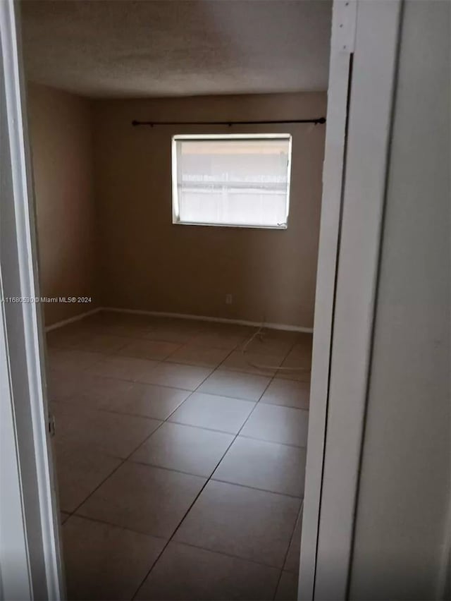 empty room with light tile patterned floors