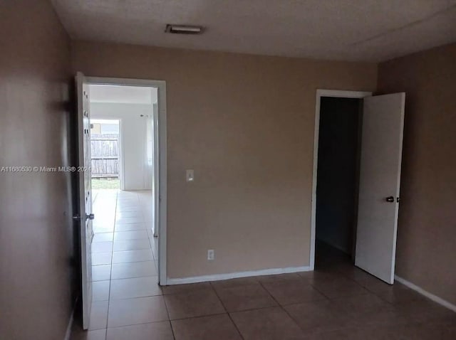 spare room with tile patterned flooring