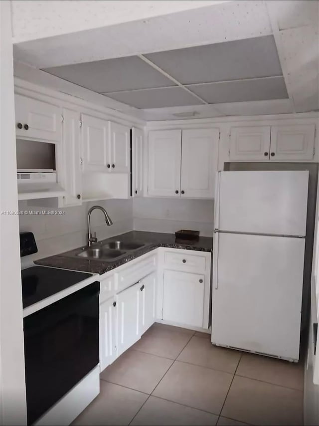 kitchen featuring white appliances, white cabinetry, sink, and exhaust hood