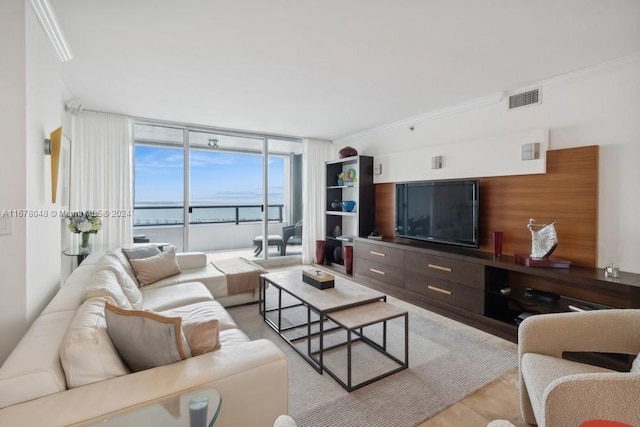 living room featuring light hardwood / wood-style floors, ornamental molding, and floor to ceiling windows