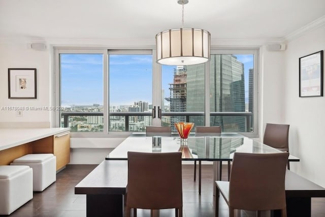 dining space with crown molding, dark wood-type flooring, and a healthy amount of sunlight