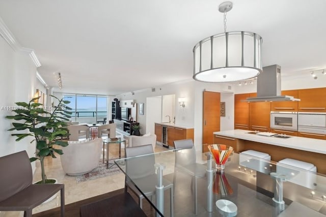 dining area with ornamental molding and light tile patterned floors