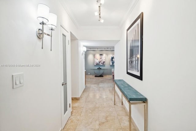 corridor with crown molding and track lighting