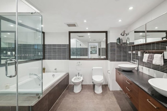 full bathroom featuring toilet, tile patterned flooring, separate shower and tub, a bidet, and vanity