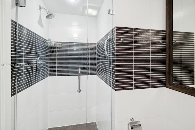 bathroom featuring a shower with door