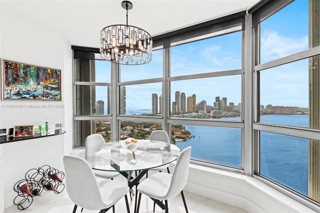 dining space with a water view and a chandelier