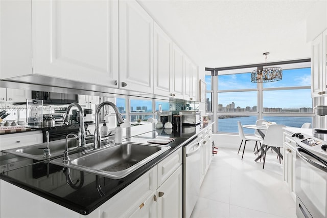 kitchen with stainless steel range with electric stovetop, white cabinetry, dishwasher, and a water view