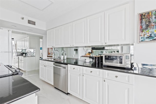 kitchen featuring white cabinets, dishwasher, and white fridge