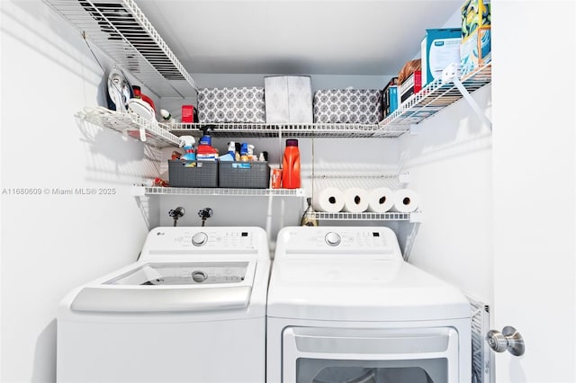 laundry area featuring washing machine and clothes dryer