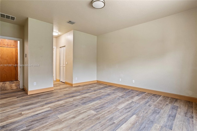 unfurnished room with light wood-type flooring