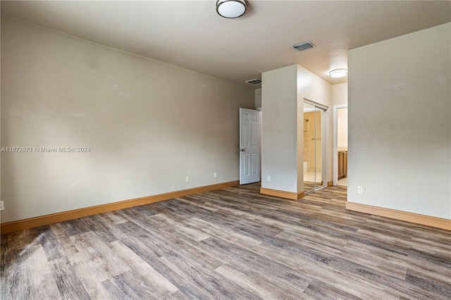 spare room with hardwood / wood-style flooring