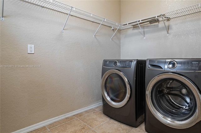 laundry area featuring separate washer and dryer and light tile patterned floors