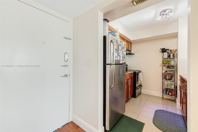 850 N Miami Ave Unit W-906, Miami, FL 33136 - kitchen with appliances with stainless steel finishes, light countertops, light tile patterned flooring, and under cabinet range hood