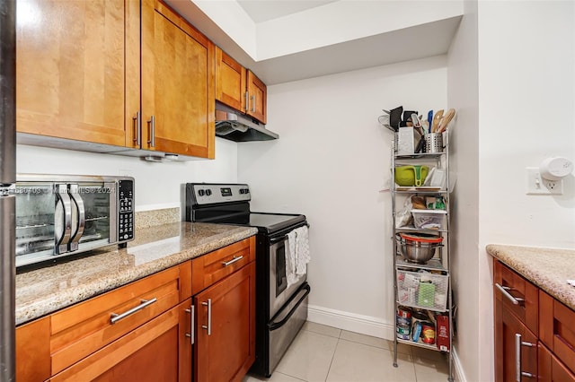 850 N Miami Ave Unit W-906, Miami, FL 33136 - kitchen with stainless steel appliances, under cabinet range hood, light stone counters, and light tile patterned flooring