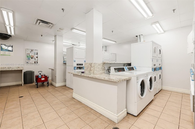 850 N Miami Ave Unit W-906, Miami, FL 33136 - communal laundry room with stacked washer / drying machine, light tile patterned floors, and washing machine and dryer