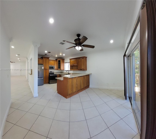 kitchen with kitchen peninsula, stainless steel appliances, ceiling fan, sink, and light tile patterned flooring