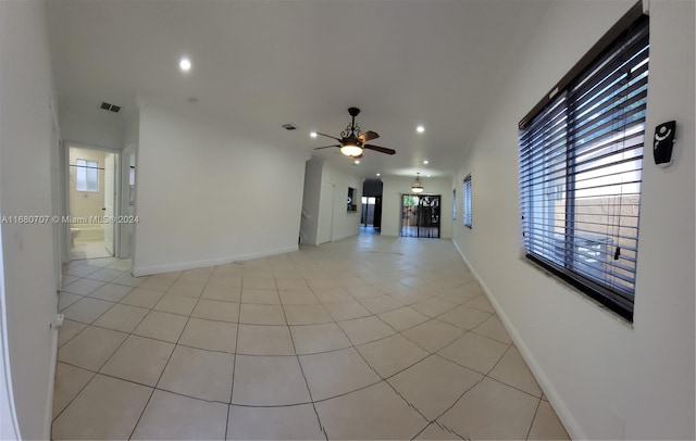 tiled spare room with ceiling fan