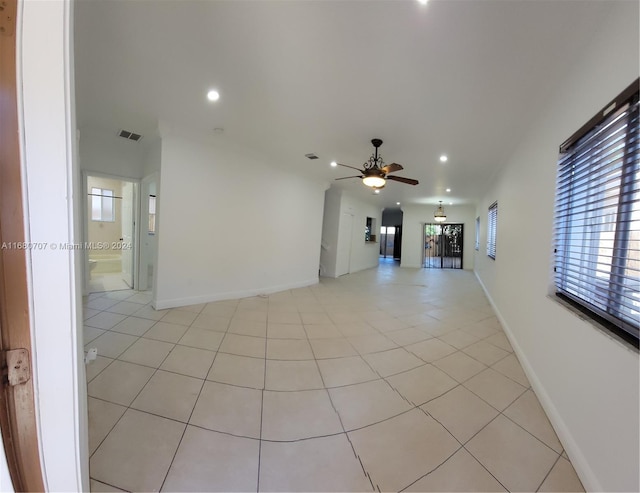 tiled empty room with ceiling fan