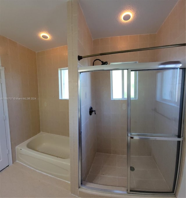 bathroom featuring plus walk in shower and a textured ceiling