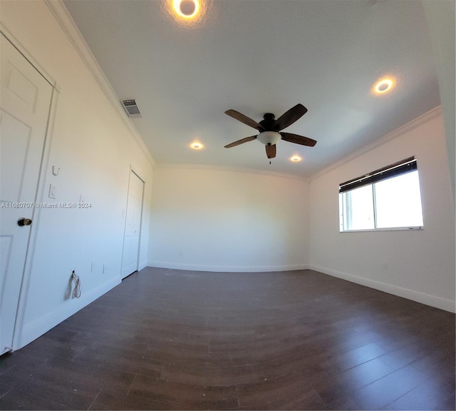 empty room featuring crown molding, dark hardwood / wood-style flooring, and ceiling fan