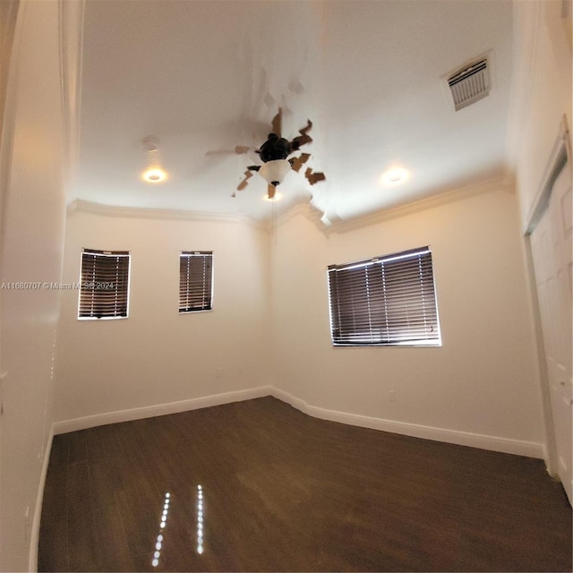 unfurnished room featuring dark hardwood / wood-style floors, ceiling fan, and ornamental molding