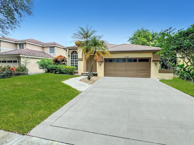 mediterranean / spanish-style home with a front yard and a garage