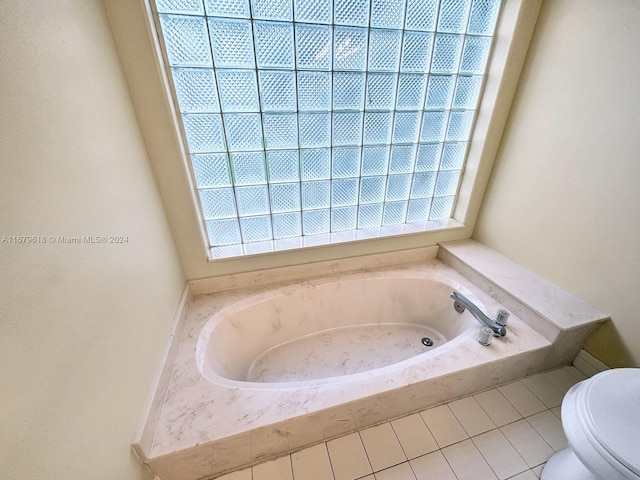 bathroom featuring toilet, tile patterned floors, and a washtub