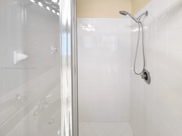 bathroom with a shower with door