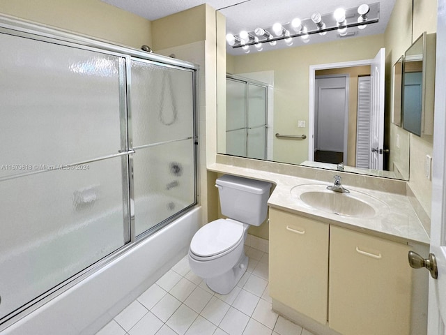 full bathroom featuring vanity, toilet, enclosed tub / shower combo, and tile patterned flooring