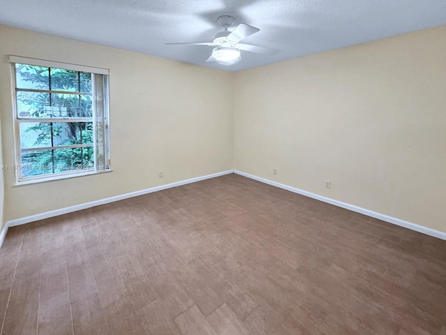 empty room featuring hardwood / wood-style floors, a textured ceiling, and ceiling fan