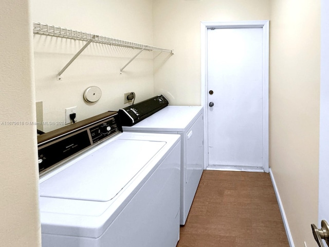 laundry room featuring independent washer and dryer and wood-type flooring