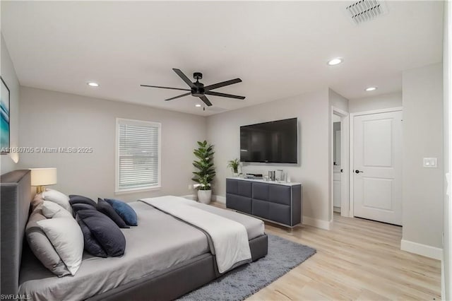 bedroom featuring recessed lighting, light wood-style floors, visible vents, and baseboards