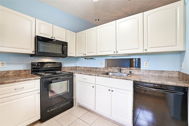 kitchen featuring sink, black appliances, light tile patterned flooring, white cabinets, and a textured ceiling