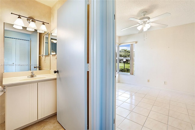 bathroom with vanity, ceiling fan, tile patterned floors, and a textured ceiling