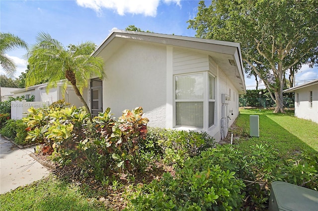 view of side of home featuring a lawn