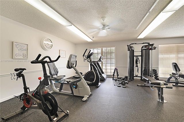 gym featuring ceiling fan and a textured ceiling