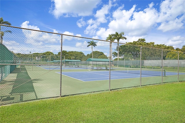 view of sport court with a yard