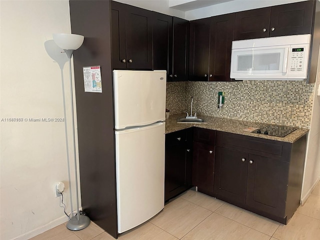 kitchen featuring sink, light tile patterned flooring, light stone counters, white appliances, and tasteful backsplash