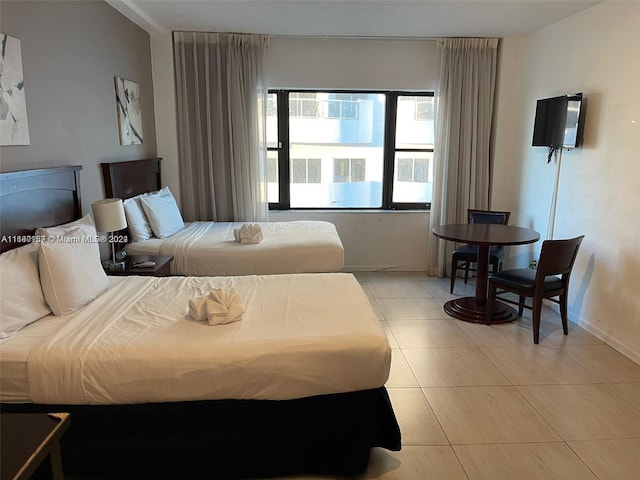 bedroom with light tile patterned floors