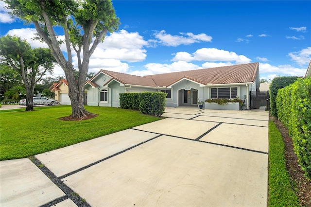 ranch-style home featuring a garage and a front yard