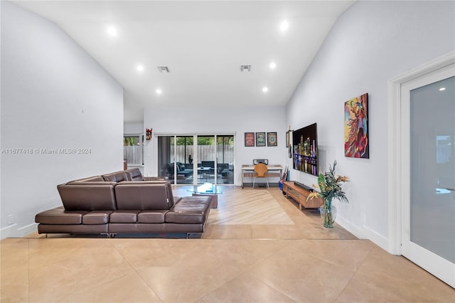 tiled living room with high vaulted ceiling